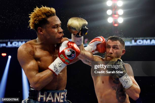 Devin Haney exchanges punches with Vasyl Lomachenko of Ukraine during their undisputed lightweight title bout at MGM Grand Garden Arena on May 20,...