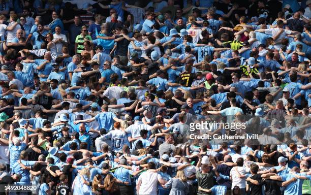 Manchester City fans do the Poznan during the Premier League match between Manchester City and Chelsea FC at Etihad Stadium on May 21, 2023 in...