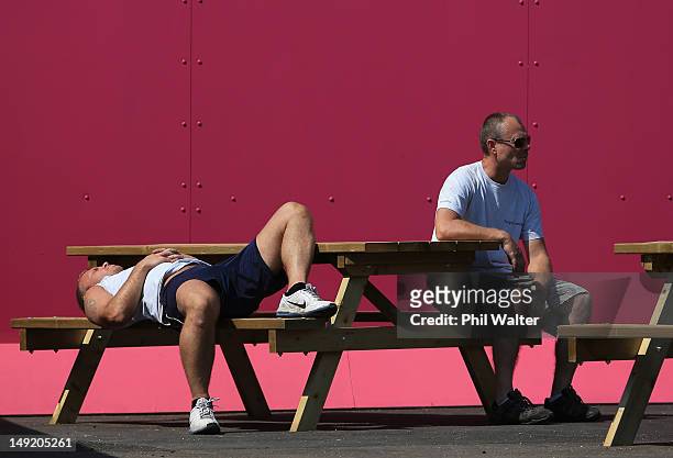 People relax in the sun in Olympic Park ahead of the London Olympic Games on July 25, 2012 in London, England.