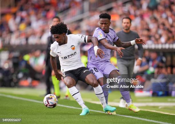 Thierry Correia of Valencia CF is challenged by Vinicius Junior of Real Madrid during the LaLiga Santander match between Valencia CF and Real Madrid...