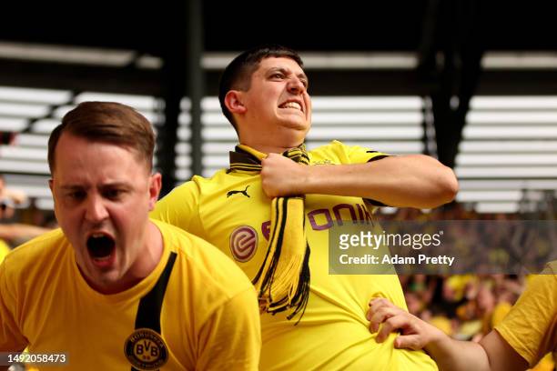 Fans of Borussia Dortmund show their support during the Bundesliga match between FC Augsburg and Borussia Dortmund at WWK-Arena on May 21, 2023 in...