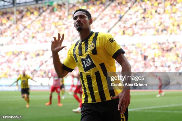 Sebastien Haller of Borussia Dortmund celebrates after scoring the team's first goal during the Bundesliga match between FC Augsburg and Borussia...