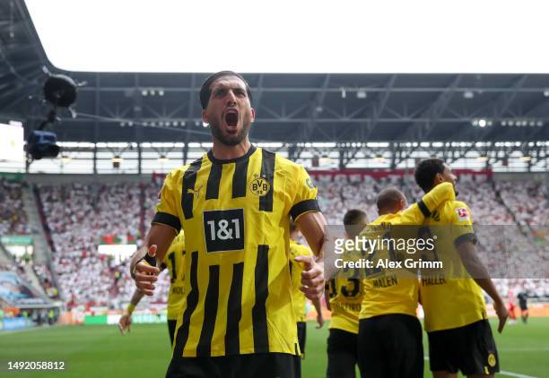 Emre Can of Borussia Dortmund celebrates after teammate Sebastien Haller scores the team's first goal during the Bundesliga match between FC Augsburg...