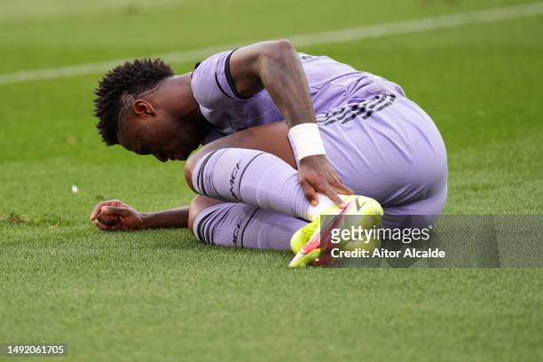 Vinicius Junior of Real Madrid holds their ankle as they lie on the floor during the LaLiga Santander match between Valencia CF and Real Madrid CF at...