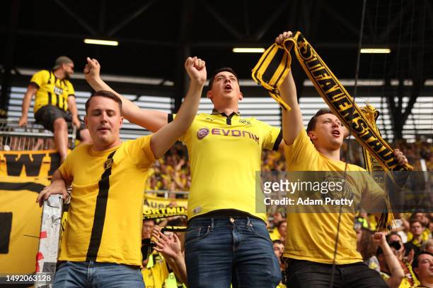 Fans of Borussia Dortmund show their support during the Bundesliga match between FC Augsburg and Borussia Dortmund at WWK-Arena on May 21, 2023 in...