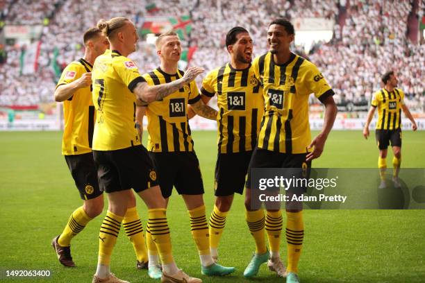 Sebastien Haller of Borussia Dortmund celebrates with teammates after scoring the team's second goal during the Bundesliga match between FC Augsburg...