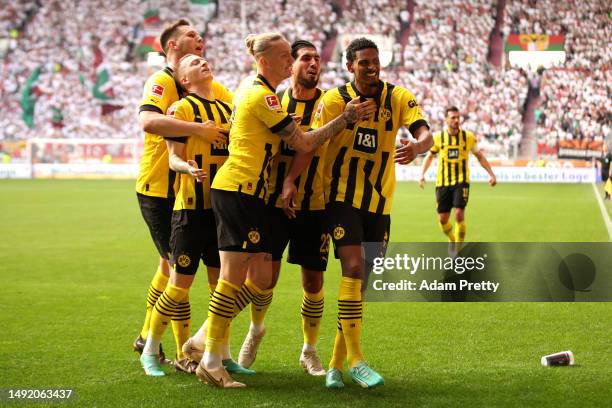 Sebastien Haller of Borussia Dortmund celebrates with teammates after scoring the team's second goal during the Bundesliga match between FC Augsburg...