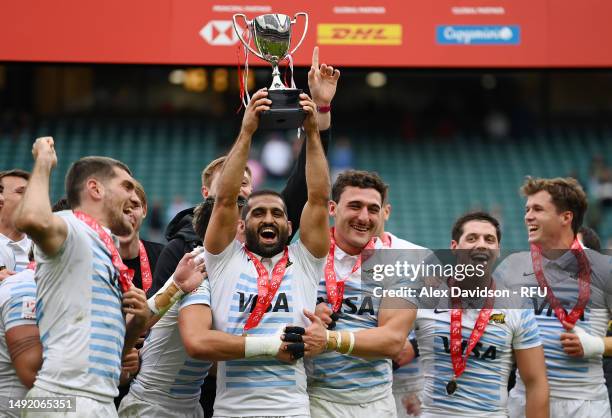 Gaston Revol of Argentina lifts the trophy with teammates after victory in the Cup Final between Argentina and Fiji the during Day Two of The HSBC...