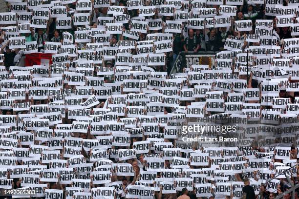 Fans of Borussia Moenchengladbach protest against the DFL prior to the Bundesliga match between Bayer 04 Leverkusen and Borussia Mönchengladbach at...