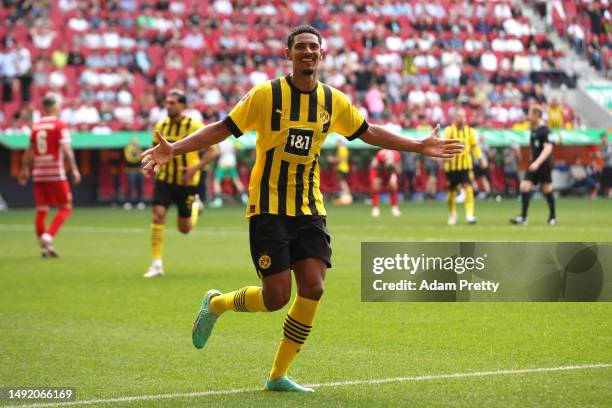 Sebastien Haller of Borussia Dortmund celebrates after scoring the team's second goal during the Bundesliga match between FC Augsburg and Borussia...