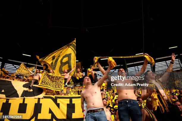 Fans of Borussia Dortmund celebrate after the team's victory in the Bundesliga match between FC Augsburg and Borussia Dortmund at WWK-Arena on May...