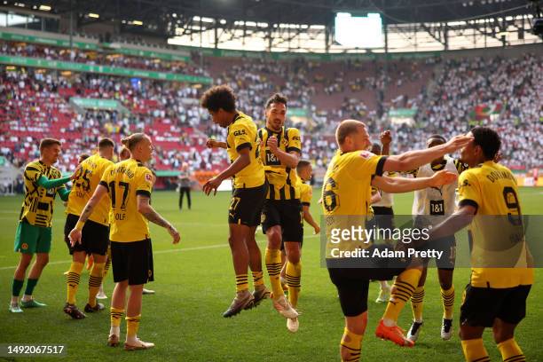 Karim Adeyemi and Mats Hummels of Borussia Dortmund celebrate after the team's victory in the Bundesliga match between FC Augsburg and Borussia...