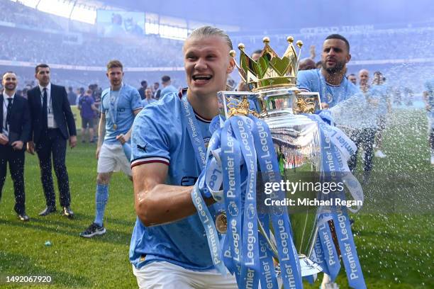 Erling Haaland of Manchester City celebrates with the Premier League trophy following the Premier League match between Manchester City and Chelsea FC...