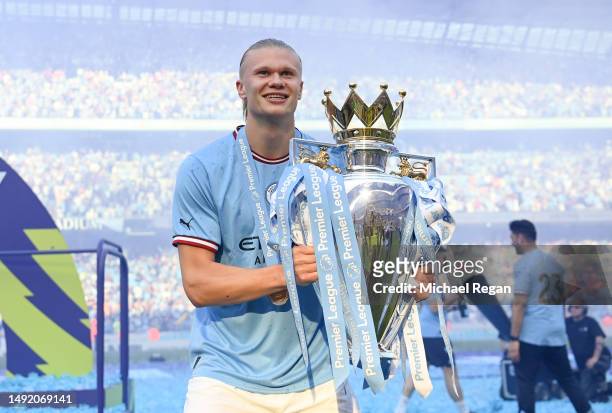 Erling Haaland of Manchester City celebrates with the Premier League trophy following the Premier League match between Manchester City and Chelsea FC...
