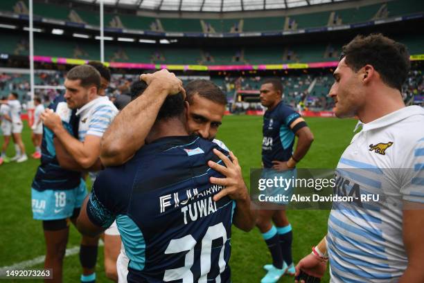 Gaston Revol of Argentina embraces Jerry Tuwai of Fiji after the Cup Final between Argentina and Fiji the during Day Two of The HSBC London Sevens at...