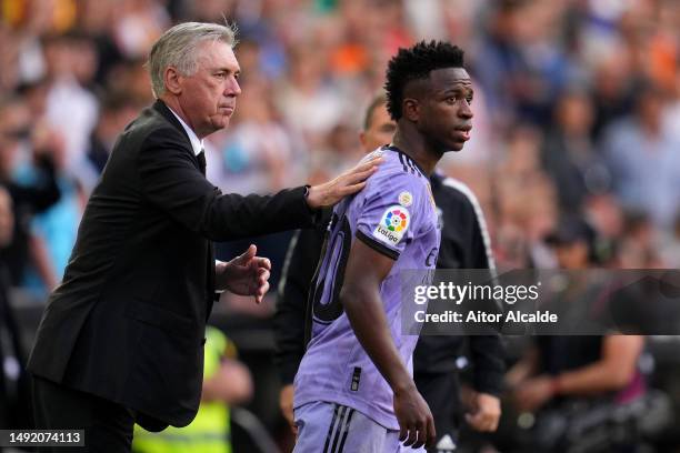 Carlo Ancelotti, Head Coach of Real Madrid, interacts with Vinicius Junior of Real Madrid during the LaLiga Santander match between Valencia CF and...