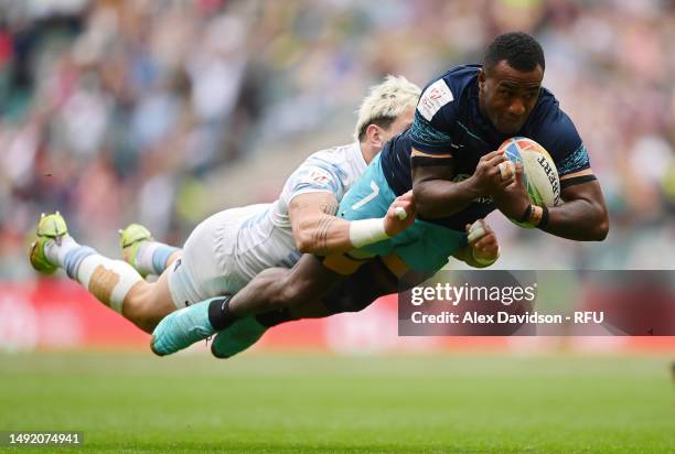 Filipe Sauturaga of Fiji scores a try under pressure from Luciano Gonzalez of Argentina during the Cup Final between Argentina and Fiji the during...