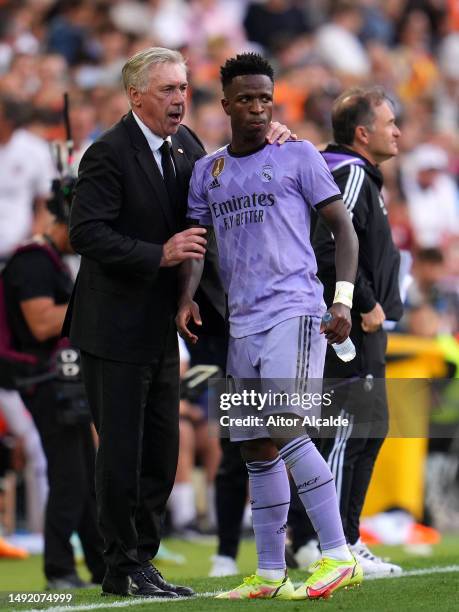 Carlo Ancelotti, Head Coach of Real Madrid, interacts with Vinicius Junior of Real Madrid during the LaLiga Santander match between Valencia CF and...