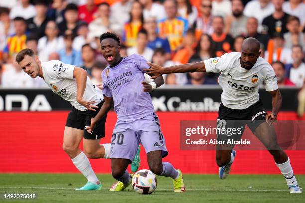 Vinicius Junior of Real Madrid is challenged by Dimitri Foulquier of Valencia CF during the LaLiga Santander match between Valencia CF and Real...