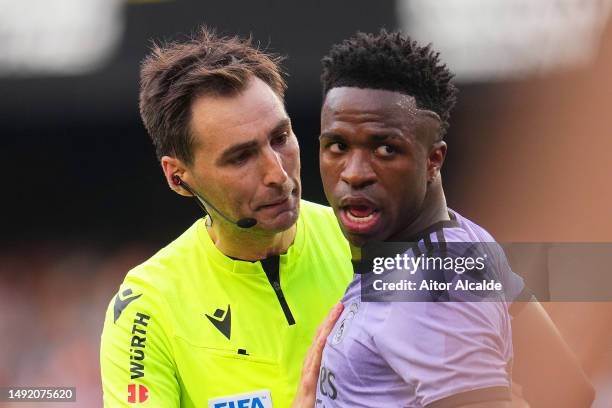 Referee Ricardo de Burgos Bengoetxea speaks with Vinicius Junior of Real Madrid during the LaLiga Santander match between Valencia CF and Real Madrid...