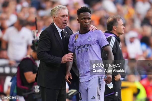 Carlo Ancelotti, Head Coach of Real Madrid, interacts with Vinicius Junior of Real Madrid during the LaLiga Santander match between Valencia CF and...