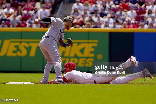 Luke Maile of the Cincinnati Reds steals second base past Gleyber Torres of the New York Yankees in the fifth inning at Great American Ball Park on...