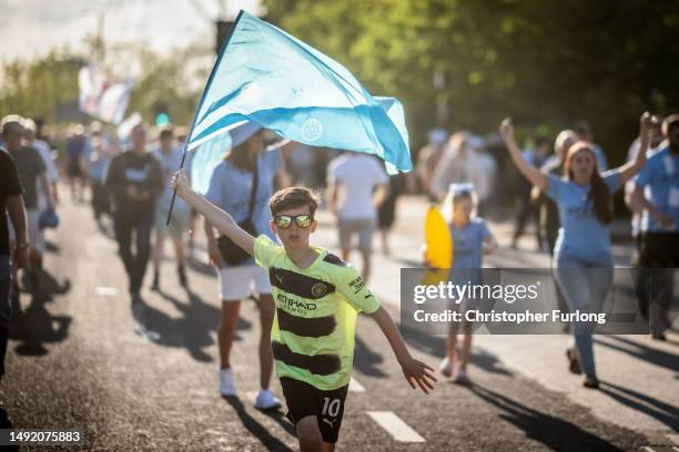 Supporters of Manchester City celebrate winning the Premier League after their match against Chelsea FC at the Etihad Stadium, on May 21st, 2023 in...