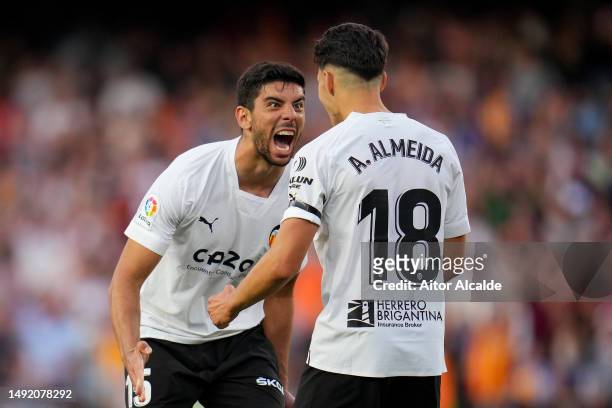 Cenk Ozkacar and Andre Almeida of Valencia CF celebrate after the team's victory in the LaLiga Santander match between Valencia CF and Real Madrid CF...