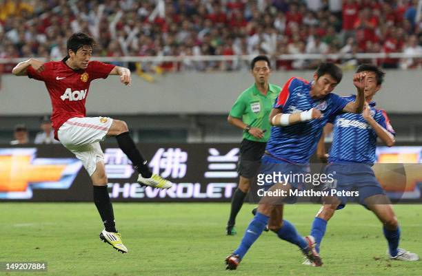 Shinji Kagawa of Manchester United scores their first goal during the pre-season friendly match between Shanghai Shenhua and Manchester United at...