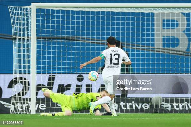 Lars Stindl of Borussia Moenchengladbach scores the team's second goal past Lukas Hradecky of Bayer 04 Leverkusen during the Bundesliga match between...