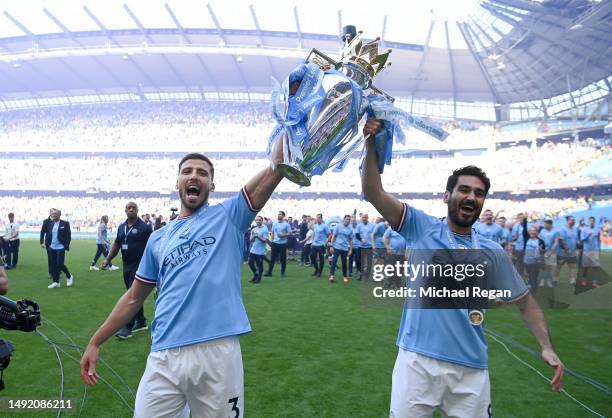 Ruben Dias and Ilkay Guendogan of Manchester City celebrates with the Premier League trophy following the Premier League match between Manchester...