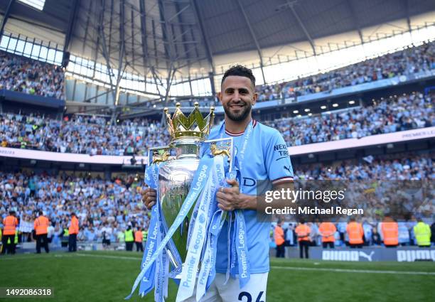 Riyad Mahrez of Manchester City poses for a photograph with the Premier League Trophy following the Premier League match between Manchester City and...