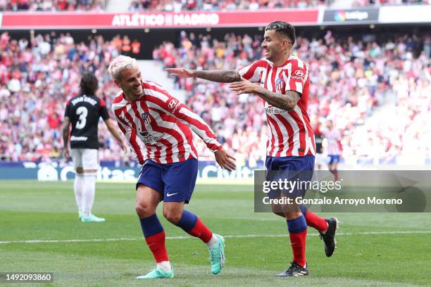 Angel Correa of Atletico de Madrid celebrates scoring their third goal with teammate Antoine Griezmann during the LaLiga Santander match between...