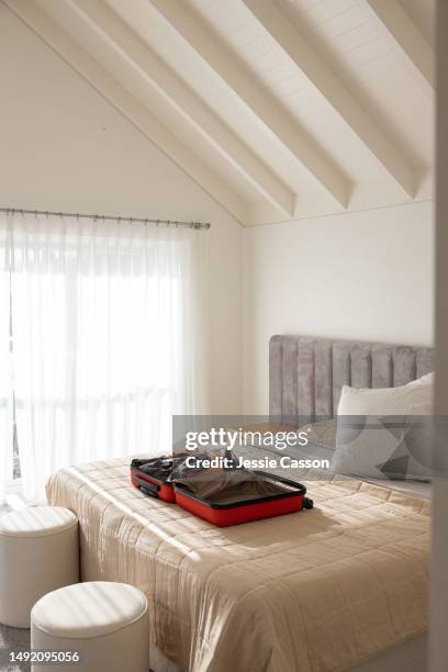 luxury bedroom with open suitcase lying on bed - bedroom no people imagens e fotografias de stock