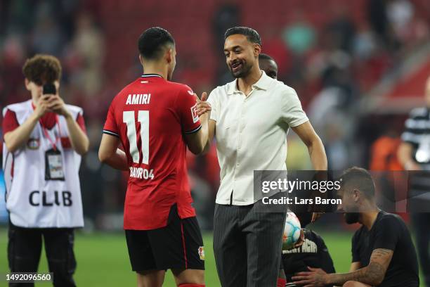 Karim Bellarabi of Bayer 04 Leverkusen celebrates with teammate Nadiem Amiri after the team's draw in the Bundesliga match between Bayer 04...