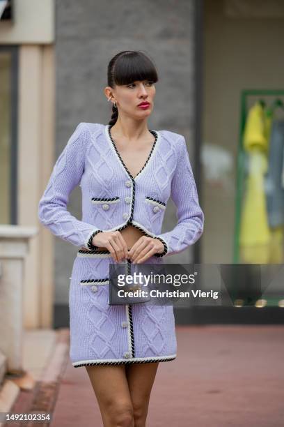Katya Tolstova wears lavender button up skirt & cropped jacket, bag, heels during the 76th Cannes film festival on May 21, 2023 in Cannes, France.
