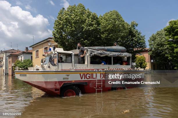 Firefighters amphibious vehicle wade through a flooded street on May 21, 2023 in Conselice, near Ravenna, Italy. Fifteen people have died and forty...