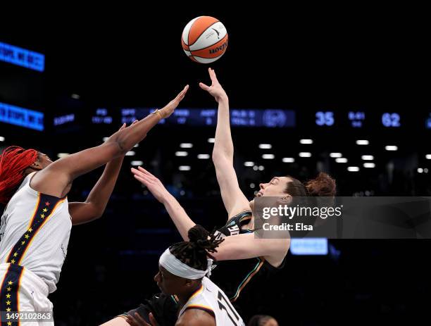 Breanna Stewart of the New York Liberty takes a shot as Aliyah Boston of the Indiana Fever defends in the second half at Barclays Center on May 21,...