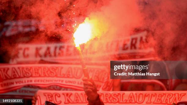 Kaiserslautern fans light flares as they show their support during the Second Bundesliga match between Karlsruher SC and 1. FC Kaiserslautern at...