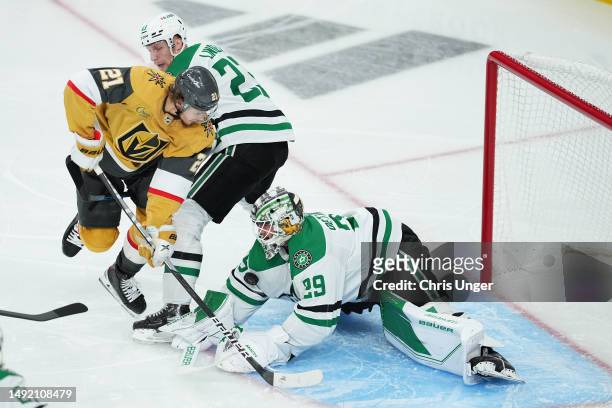 Jake Oettinger of the Dallas Stars blocks a shot by Brett Howden of the Vegas Golden Knights as Esa Lindell of the Dallas Stars defends during the...