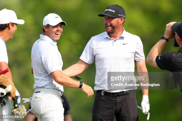 Michael Block of the United States, PGA of America Club Professional, celebrates his hole-in-one on the 15th tee with Rory McIlroy of Northern...