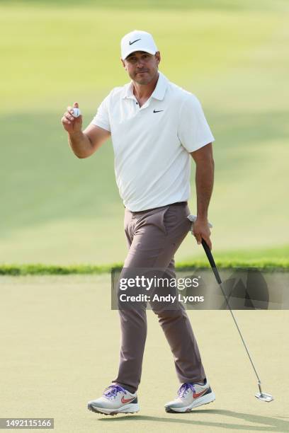 Brooks Koepka of the United States waves after making birdie on the 12th green during the final round of the 2023 PGA Championship at Oak Hill...