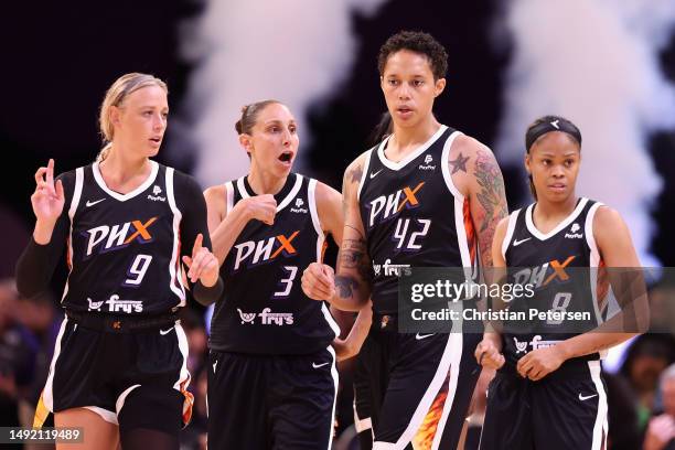 Sophie Cunningham, Diana Taurasi, Brittney Griner and Moriah Jefferson of the Phoenix Mercury walk onto the court during the second half of the WNBA...