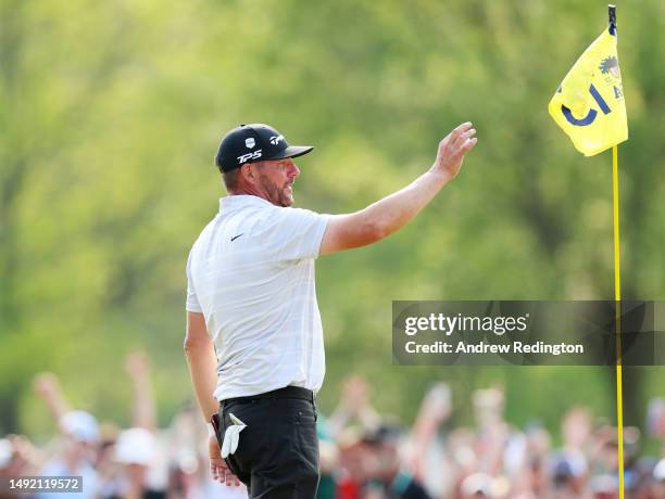 Michael Block of the United States, PGA of America Club Professional, celebrates his hole-in-one after taking his ball from the cup on the 15th green...