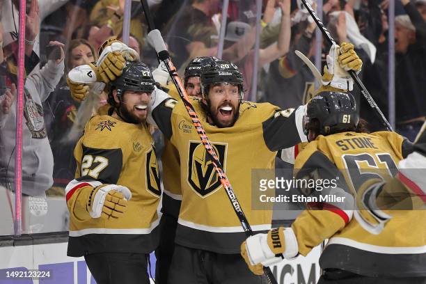 Shea Theodore, Chandler Stephenson and Mark Stone of the Vegas Golden Knights celebrate after Theodore and Stone assisted Stephenson on a...