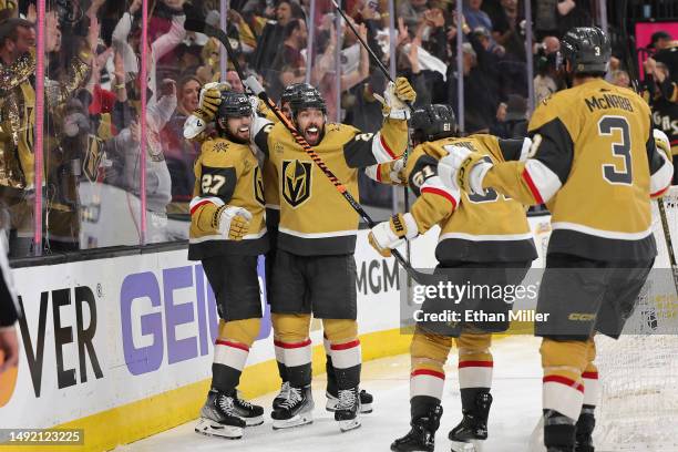 Shea Theodore, Chandler Stephenson, Mark Stone and Brayden McNabb of the Vegas Golden Knights celebrate after Theodore and Stone assisted Stephenson...