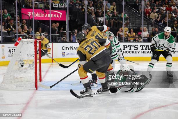 Chandler Stephenson of the Vegas Golden Knights scores a game-winning overtime goal against the Dallas Stars with teammates in Game Two of the...