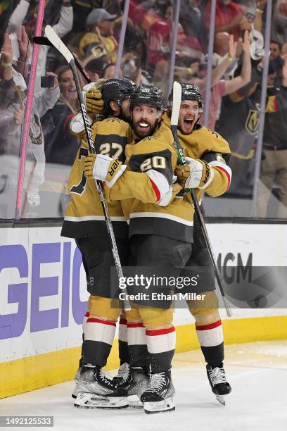 Shea Theodore, Chandler Stephenson and Brett Howden of the Vegas Golden Knights celebrate after Theodore assisted Stephenson on a game-winning...