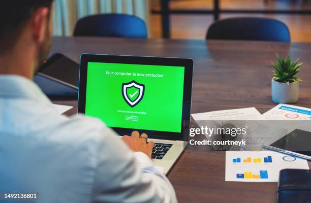 businessman looking at a antivirus security log in screen on a computer. - security screen icons stock pictures, royalty-free photos & images