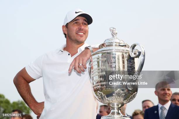 Brooks Koepka of the United States smiles alongside the Wanamaker Trophy after winning the 2023 PGA Championship at Oak Hill Country Club on May 21,...